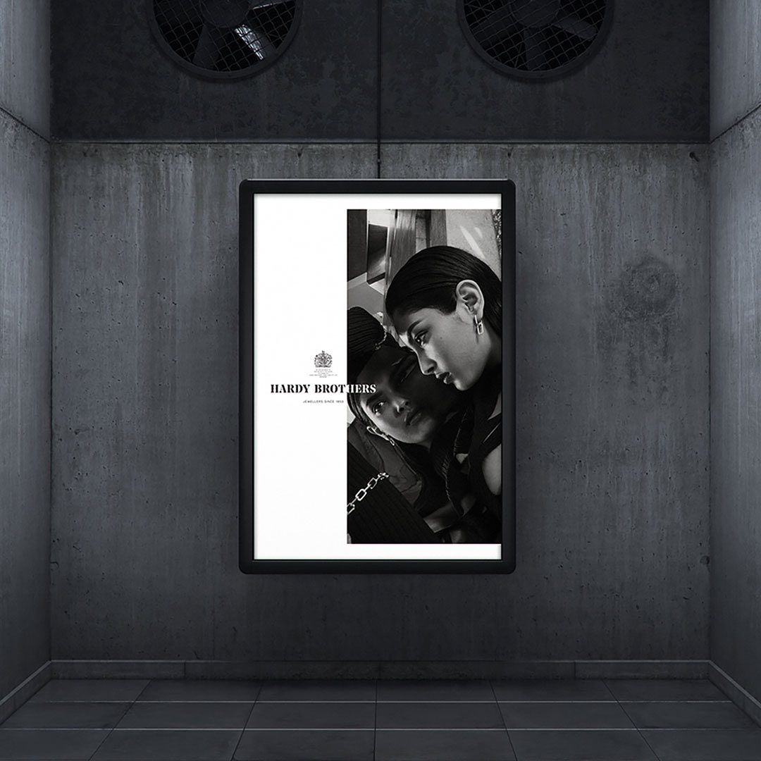 Monochrome poster featuring two women in a dimly lit urban setting with concrete walls and visible ventilation fans.