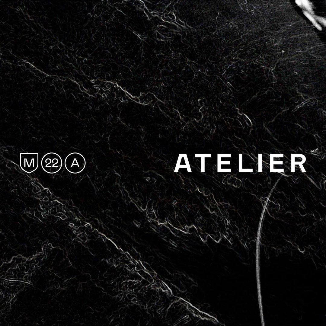 Abstract dark background with swirling textures and prominent Atelier text, creating a sophisticated visual experience.