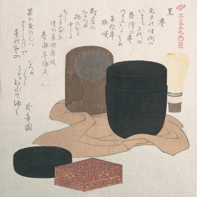 Still life of traditional Japanese tea ceremony items arranged on a cloth, including a tea caddy, a box, and a ceramic container.