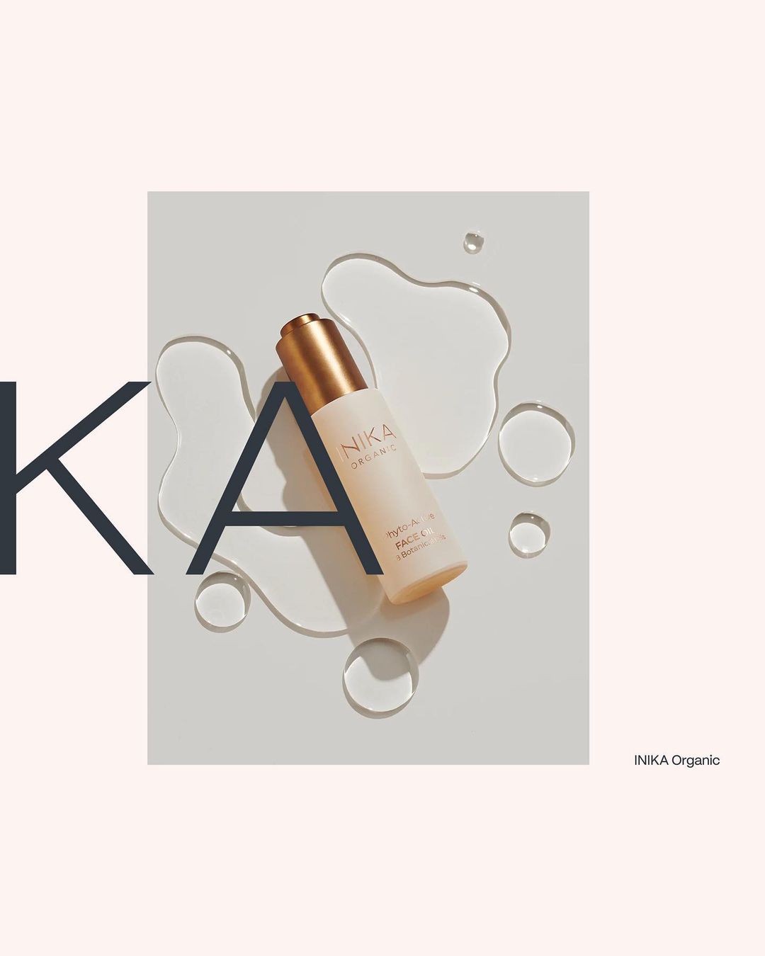 Product shot of NIKA Organic face serum against a white surface with water droplets, accented by oversized typography elements.