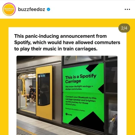 Interior view inside a train carriage with advertisement for Spotify on the exterior with people seated in the background.
