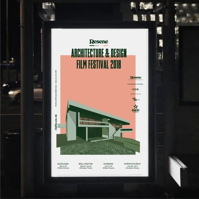 Poster featuring architectural design film festival 2018, showcasing modern building illustration on display at a bus stop at night.