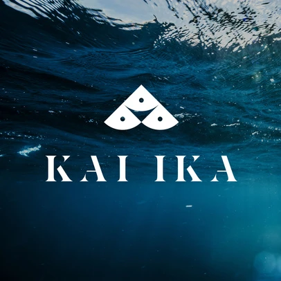 Underwater shot of a logo with wave patterns in shades of blue and white, centered, beneath the surface of the ocean.