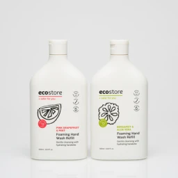 Two white plastic foaming hand wash refill bottles featuring black and coloured label illustrations against a seamless white background.