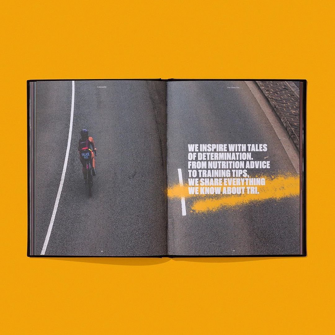 Book spread shows cyclist on asphalt road with text about determination and training tips, presented on a golden yellow background.