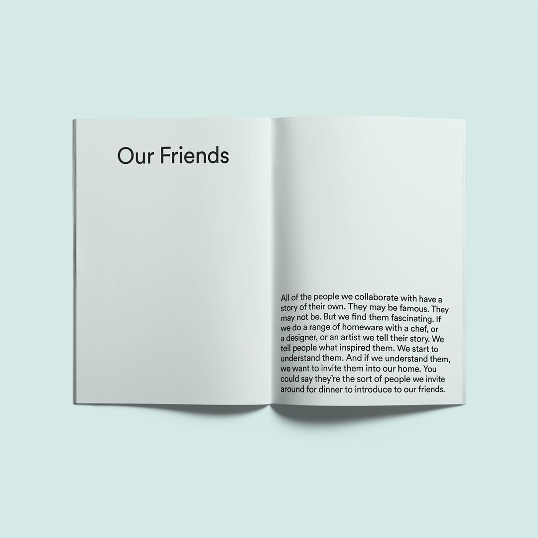 An open book on a light blue surface. The left page has the title 'Our Friends' and the right page has a text block.