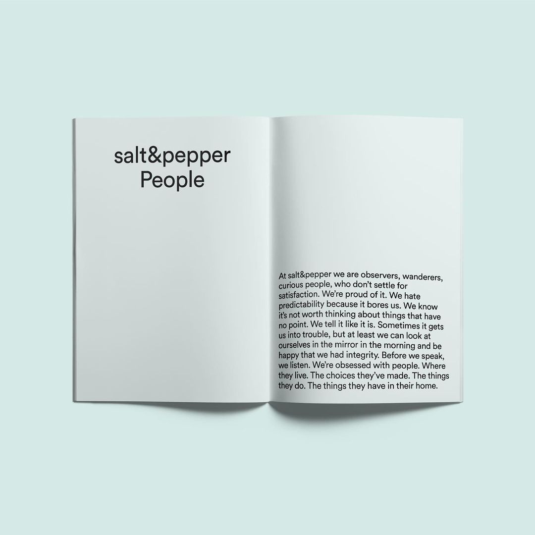 Open book on a white surface featuring 'salt&pepper People' on the left page and a block of descriptive text on the right.