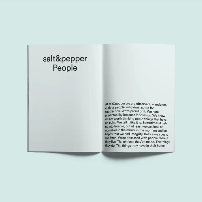 Open publication spread featuring black sans-serif typography reading salt and pepper people on a white page against a pale background