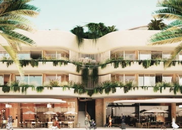 Modern multi-story commercial building exterior in Sydney with curved balconies, lush trailing greenery, and palm fronds framing the view.