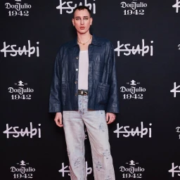 Man standing against a black step and repeat backdrop featuring Ksubi and Don Julio branding in Sydney.