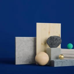 Abstract still life arrangement of geometric shapes, wooden panels, textured stone blocks, and spheres on a deep blue background