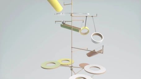 A complex wooden and metal kinetic sculpture with rolling spheres and rings against a plain background.