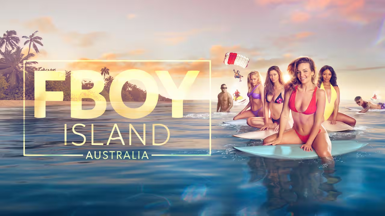 Group of women and men on surfboards in the ocean for 'F Boy Island Australia' TV show promo on a tropical island at sunset.