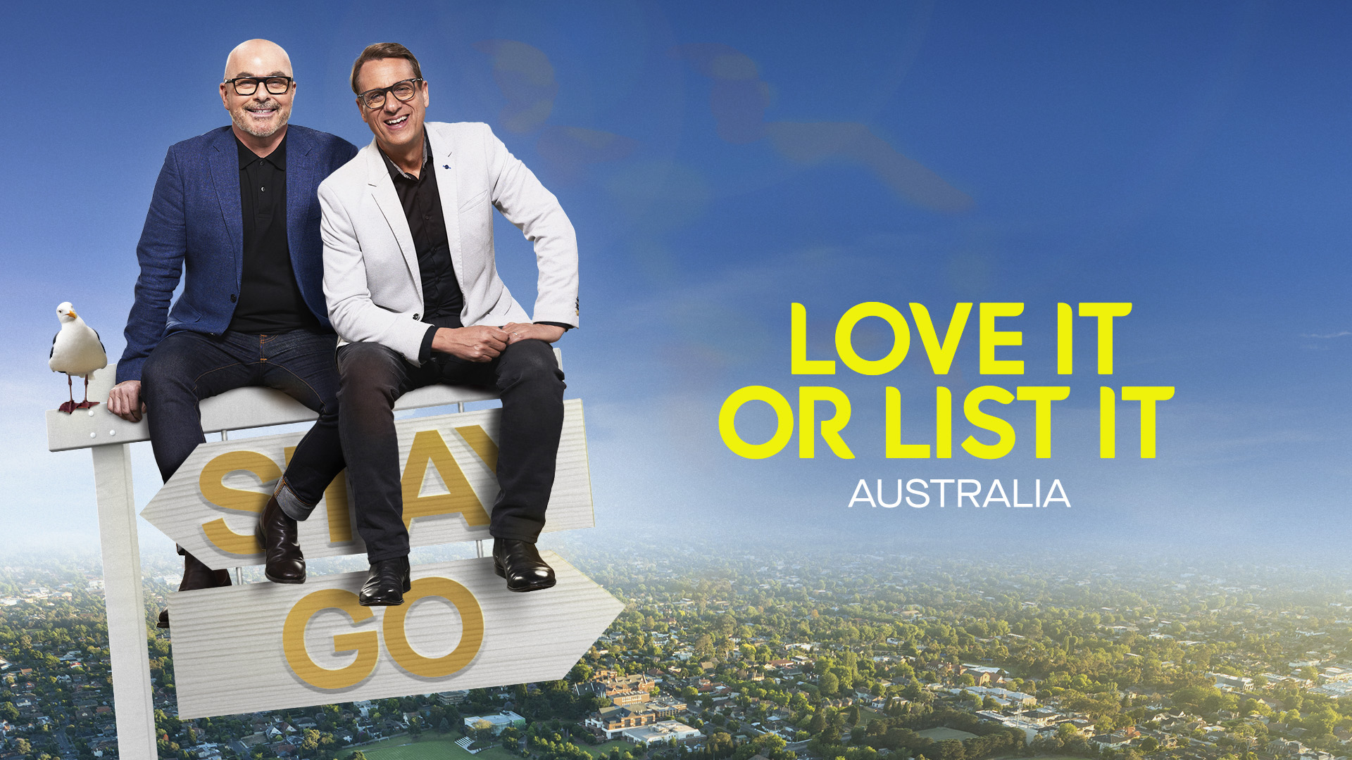 Two men sit on a sign against a blue sky and a city background; a seagull perches on the left side of the sign. 'Love it or List it' text is present.