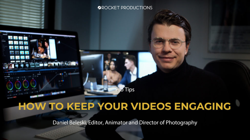 Professional video editor smiling in an office with dual monitors displaying timeline and footage, and branding: Rocket Productions.