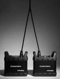 Two black Camvan power packs connected by cables against a grey seamless studio background.
