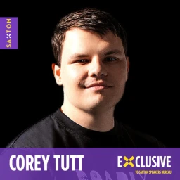 Portrait of Corey Tutt smiling against a dark background with purple branded banners in top left and bottom right corners.