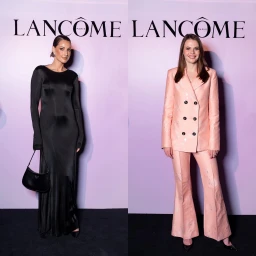 Two women posing on a black carpet in front of a branded Lancome backdrop in Sydney