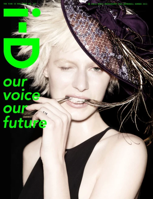Fashion magazine cover featuring a model with short blonde hair, a feathered hat, and green text overlay on a black background.