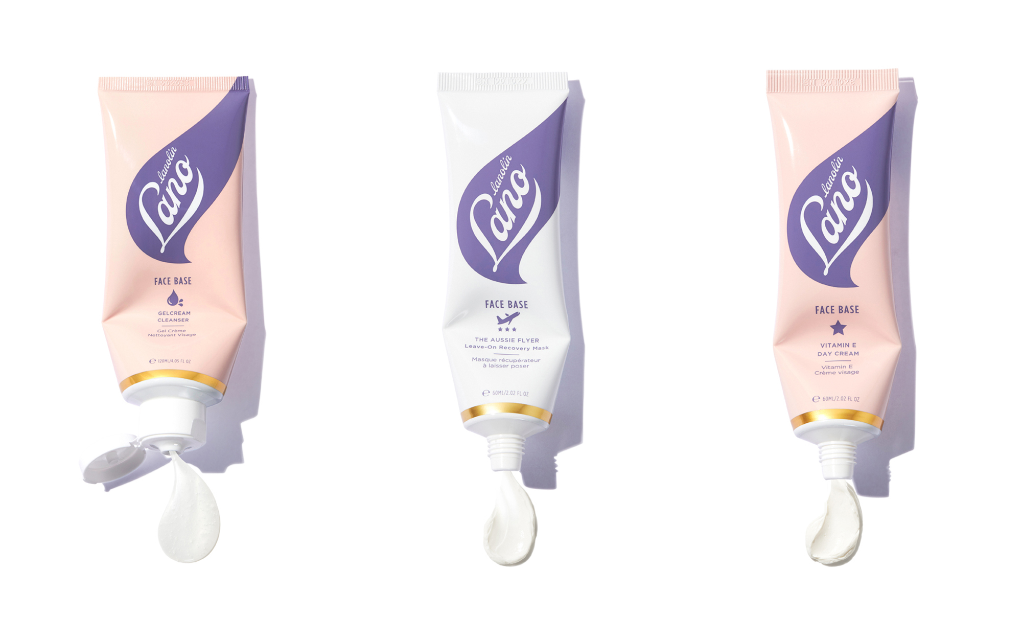 Three tubes of Lanolin Lano face base in a row, each with a squeeze of product emerging from the tube's opening, against a white background.