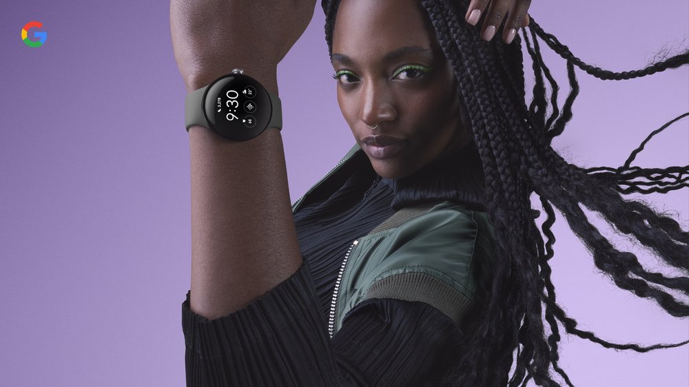Woman showcasing a smartwatch on her wrist with a minimalist design, set against a light purple background with the Google logo in the corner.
