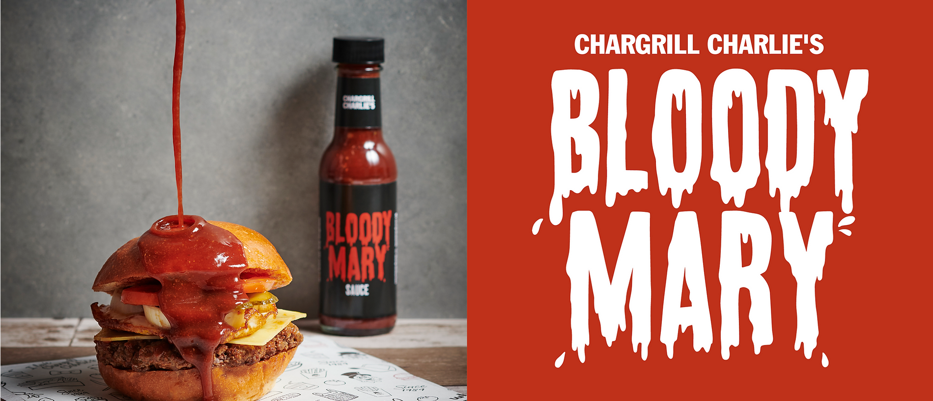 A burger with bloody mary sauce being poured on top, with a bottle of the sauce on the side and a graphic of the brand's logo.