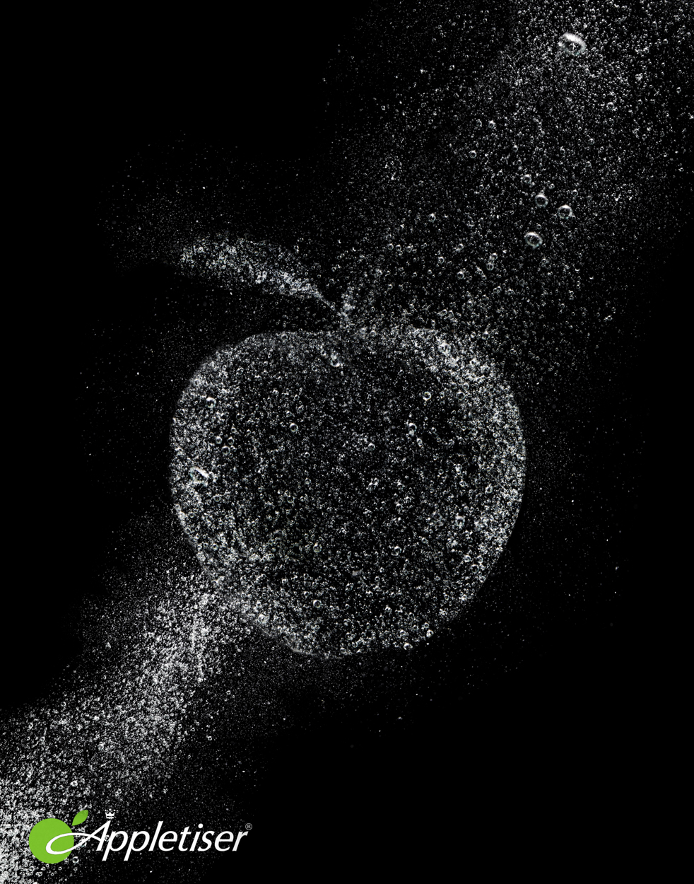 Bubbles form the shape of an apple with a stem, against a black background; Appletiser logo in the lower-left corner.