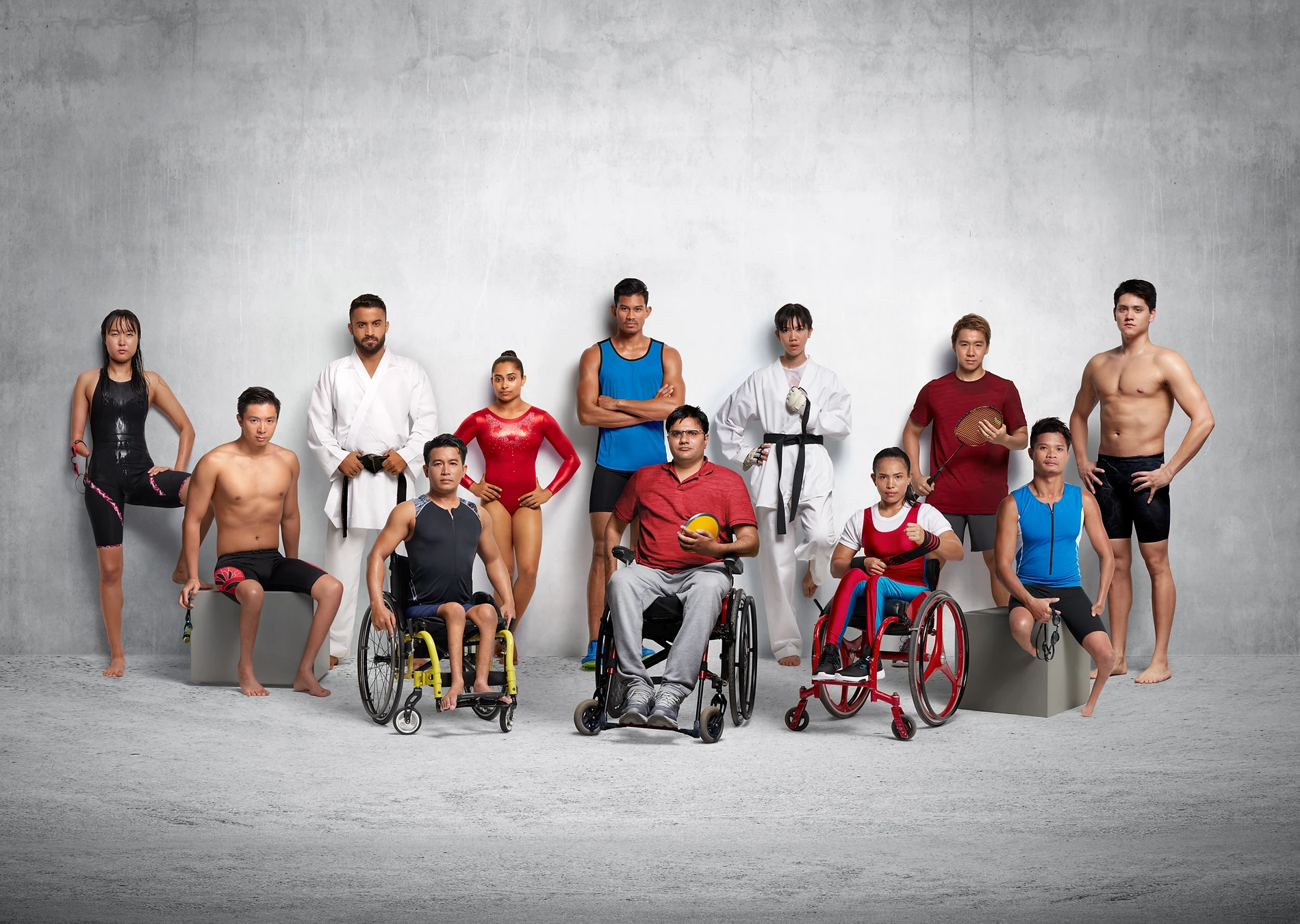 Diverse group of athletes, some with disabilities, showcasing various sports attire and equipment against a textured gray backdrop.