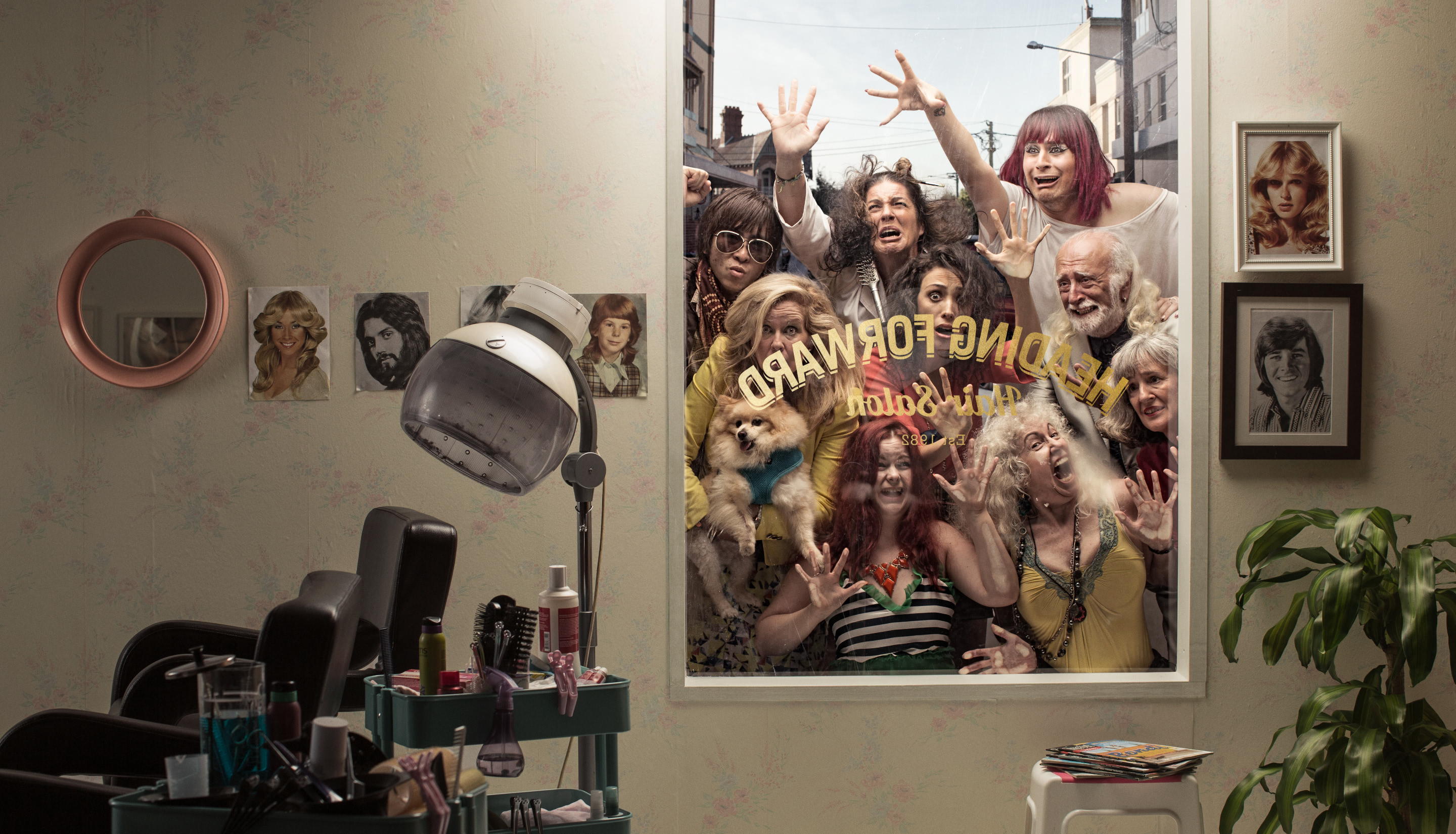 Retro-style salon interior with vintage equipment, framed photos on the wall, and a group of diverse, expressive people outside the window.