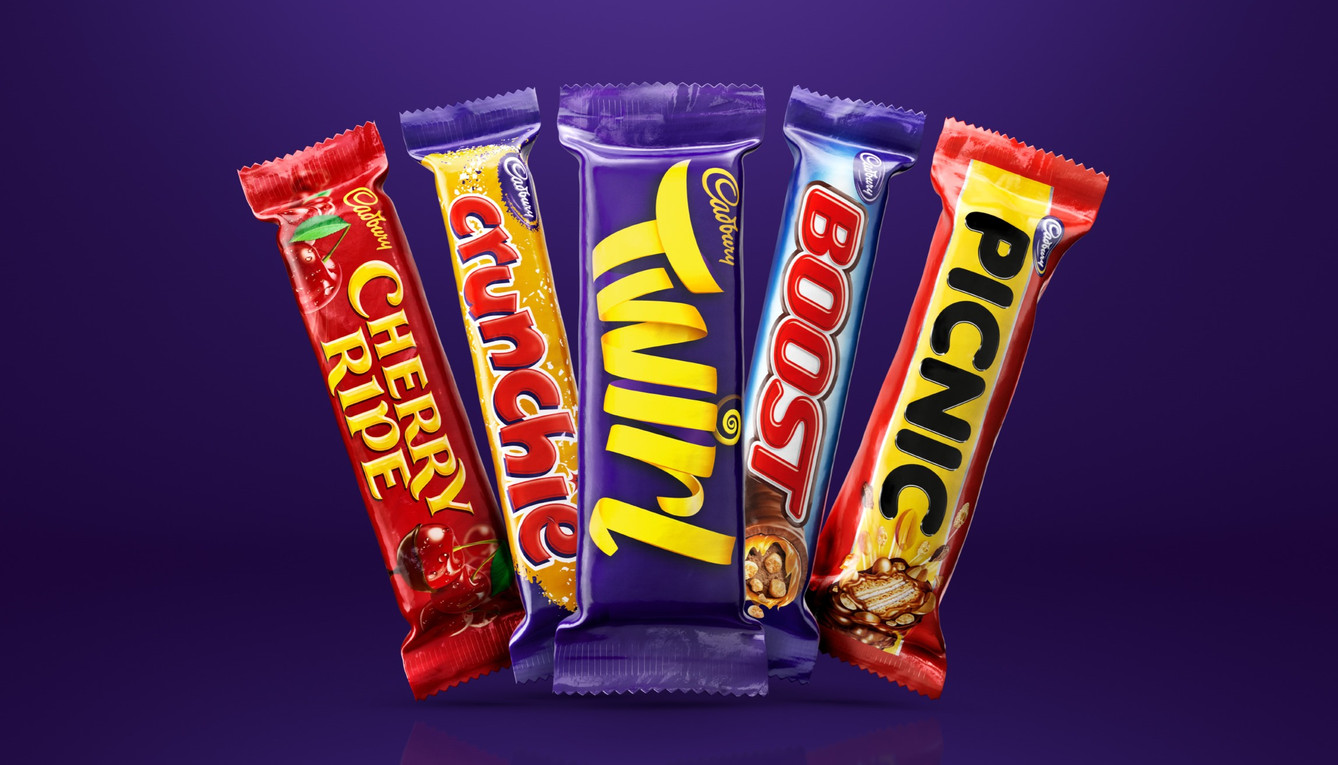 Five Cadbury chocolate bars: Cherry Ripe, Crunchie, Twirl, Boost, and Picnic, arranged against a gradient purple background.