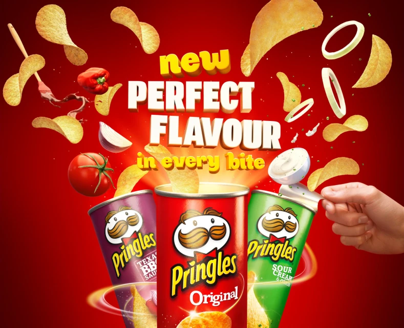 Three Pringles cans with potato chips and various toppings floating around on a bright red background. Food and beverage theme.