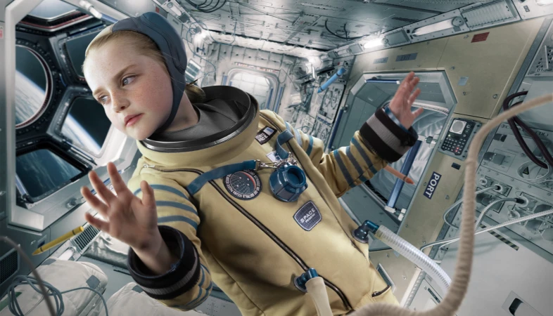 A young child in a yellow spacesuit inside a spaceship, looking out a porthole at Earth. The space station interior is visible.