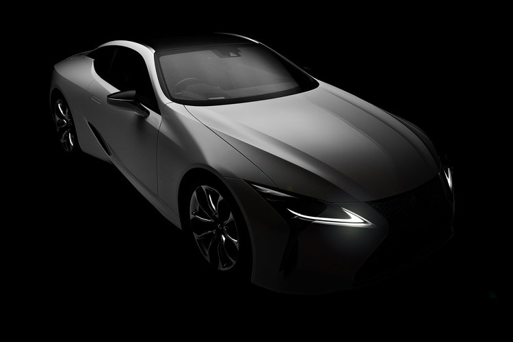 Sleek silver Lexus coupe showcasing modern automotive design with illuminated headlights against a dramatic black backdrop.