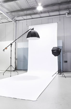Professional photo studio setup with large white seamless backdrop and lighting equipment in Melbourne