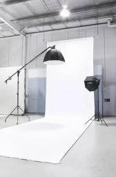 Professional photo studio setup with large white seamless backdrop and lighting equipment in Melbourne