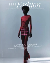 Black model in red long-sleeve top and patterned miniskirt with platform heels standing against a grey background