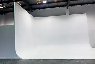 Large white cyclorama wall inside an industrial photography studio in Melbourne by Tachi Studios