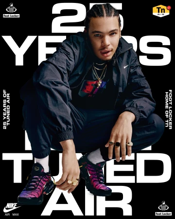 Man crouching, wearing black jacket and sneakers with purple accents, posed in front of black-and-white Nike Air Max ad.