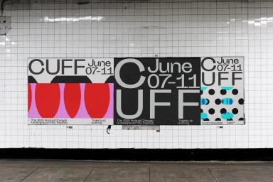 Three posters for the Chicago Underground Film Festival mounted on white tiled wall above concrete ground