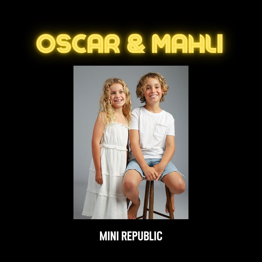 Two smiling children, a boy and a girl, pose indoors in a studio with bright lighting; promotional image for Mini Republic clothing.