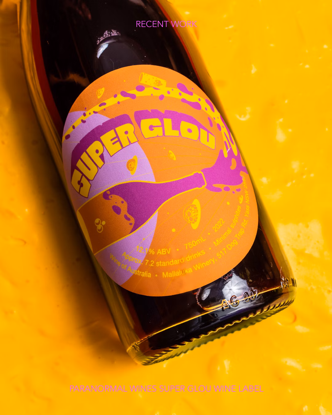 Artistic product shot of a wine bottle with a colorful label on a bright yellow textured background. Modern product photography.