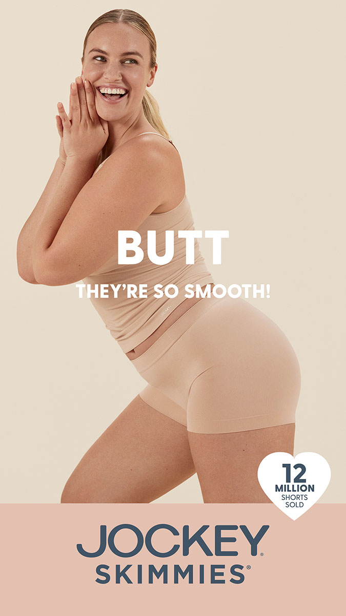 A smiling woman wearing a tank top and shorts poses in a studio. The image features the brand logo and tagline for Jockey Skimmies.