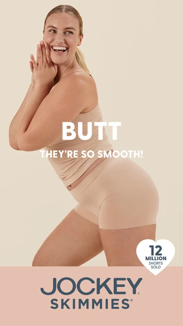 A smiling woman wearing a tank top and shorts poses in a studio. The image features the brand logo and tagline for Jockey Skimmies.