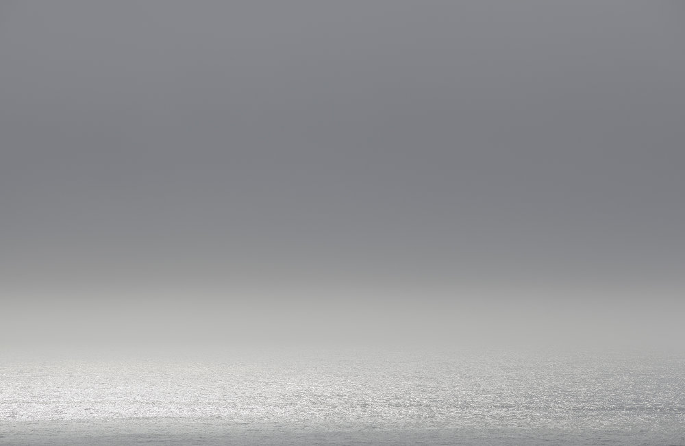 Minimalist landscape seascape with grey overcast sky over a calm ocean horizon photographed by Adam Kola in Sydney