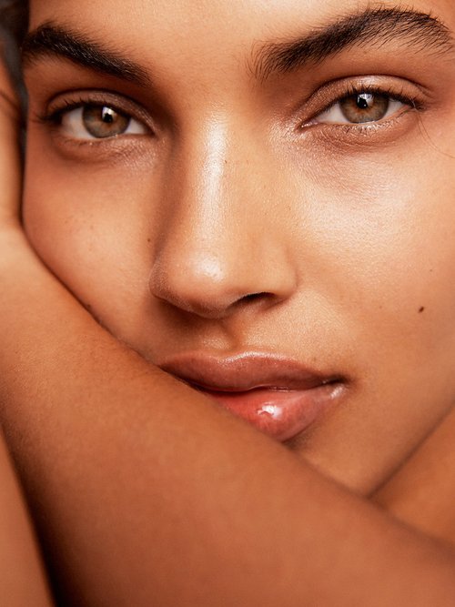 Close-up portrait of a fair-skinned adult female with brown eyes, visible lips, and facial features. The focus is on skincare and beauty.
