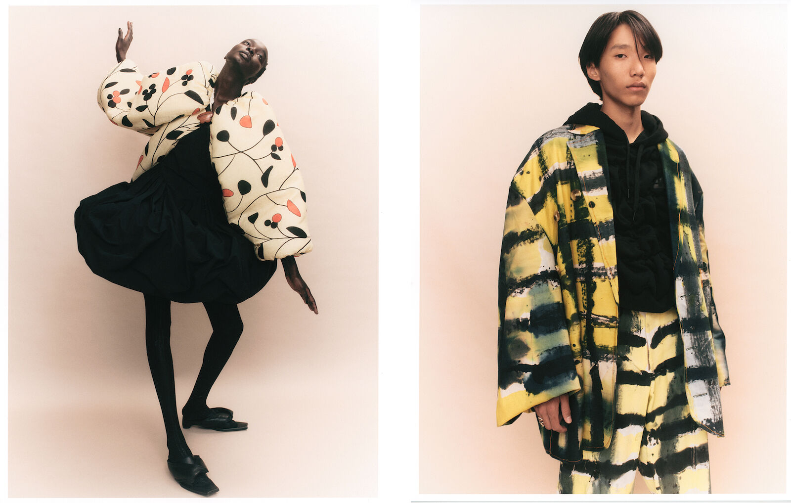 Two models showcase fashion designs against a neutral background, one in an floral top and black skirt and the other in a patterned jacket and pants.