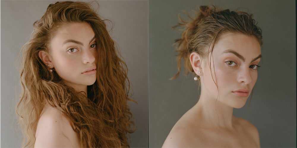 Portrait of a young woman with long, wavy auburn hair and fair skin, posed in front of a neutral gray backdrop, split view with wet hair.