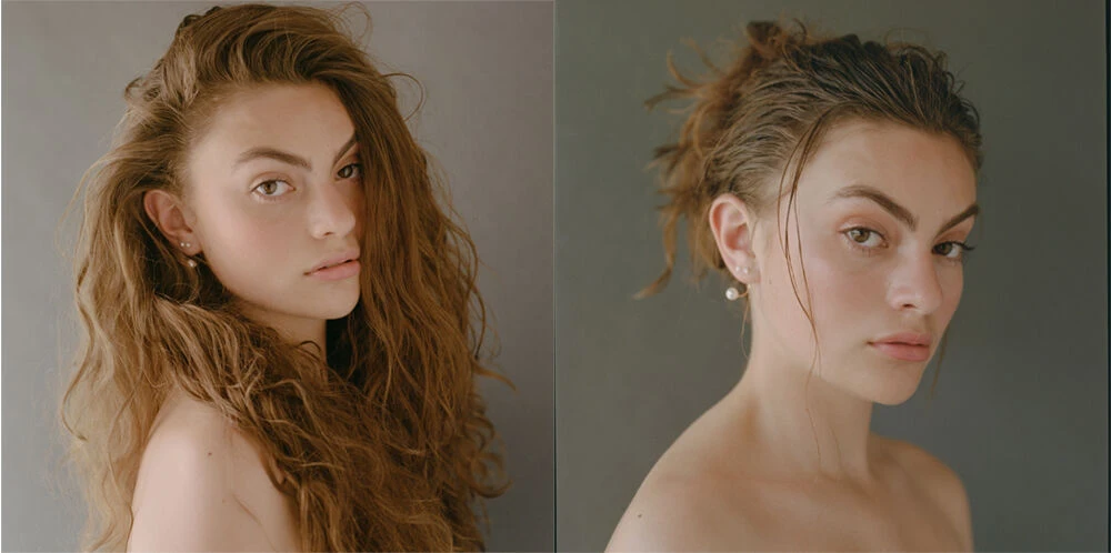 Portrait of a young woman with long, wavy auburn hair and fair skin, posed in front of a neutral gray backdrop, split view with wet hair.