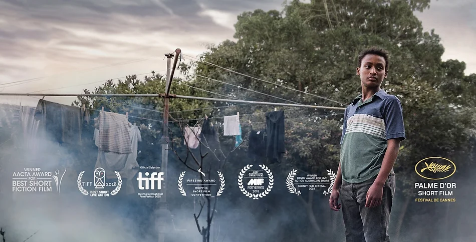Film poster featuring a young man standing outdoors with a clothesline in the background and film festival award logos overlaid.