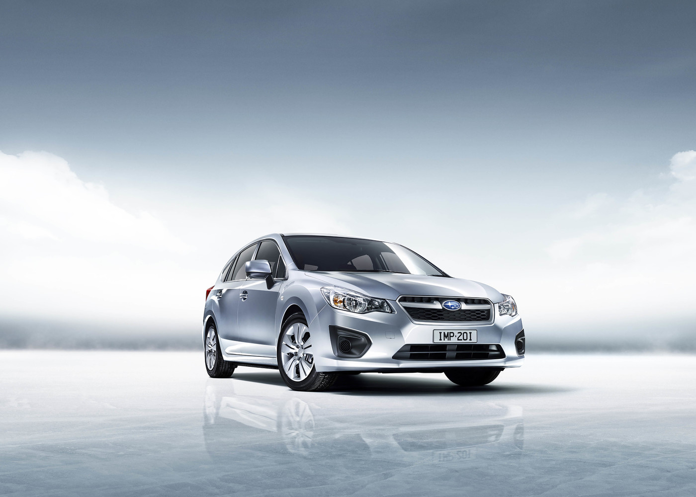 Silver Subaru Impreza stands out in a minimalist automotive studio shot with a light blue backdrop, showcasing its sleek design.